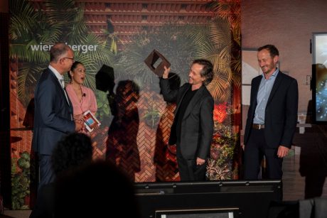 The Grand Prize winners handing over a brick of the winning project to Heimo Scheuch