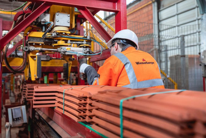 Factory worker checking packaging machine