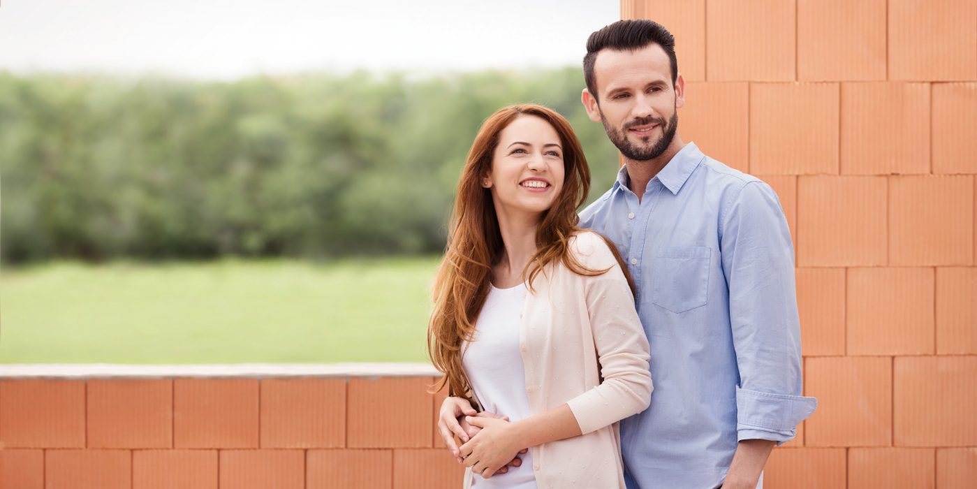 Couple inside their future home inside building shell