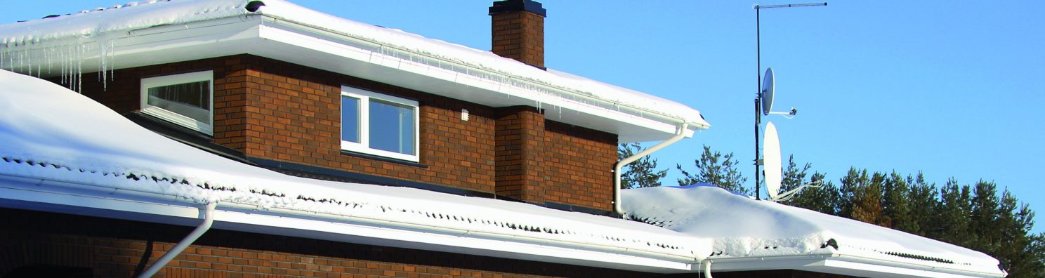 Brown brickhouse in wintertime with lot's of snow