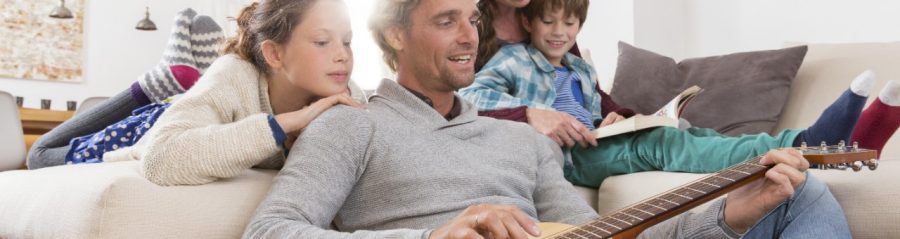 Family situation with guitar in living room